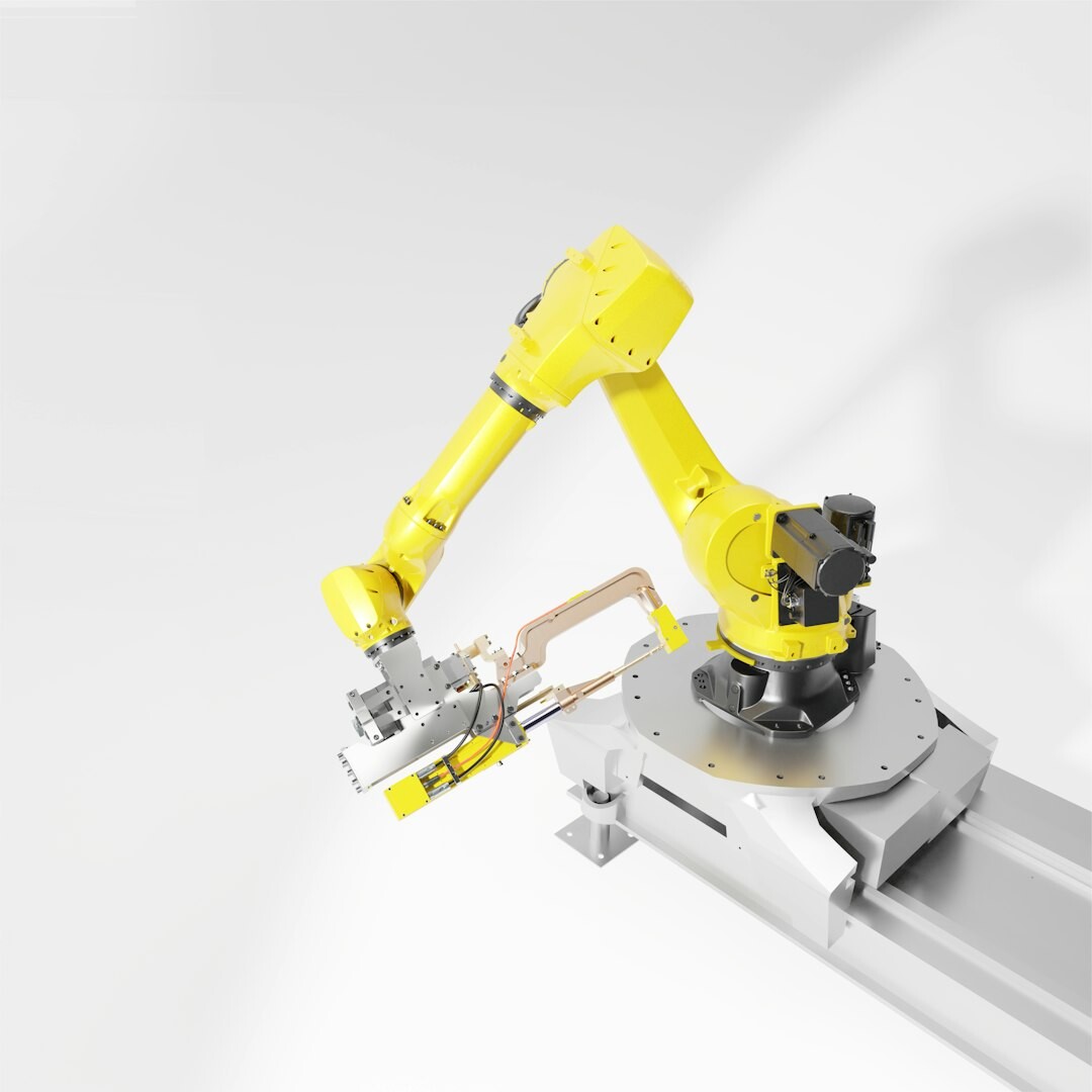 Industrial orange robotic arm performing automated assembly in modern manufacturing factory